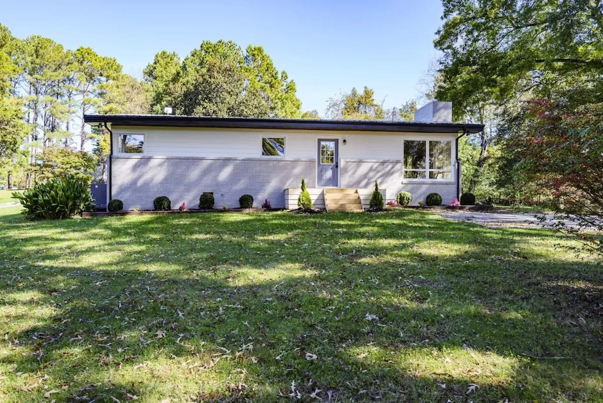 Featuring modern architecture, landscaped grounds, and broad entrance steps, this exterior shot highlights spaces perfect for outdoor gatherings, playtime, and evening relaxation. It emphasizes the spaciousness and accessibility of the yard, ideal for after-adventure family moments.